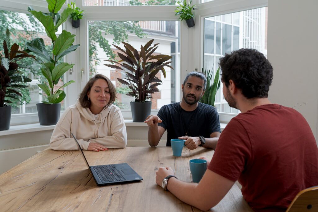 woman in white hijab sitting beside man in red crew neck t-shirt